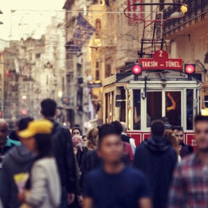 Historic red tram on crowded Istiklal Avenue in Taksim, Istanbul