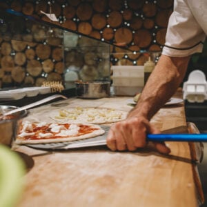 Pizza chef preparing a pizza at a restaurant