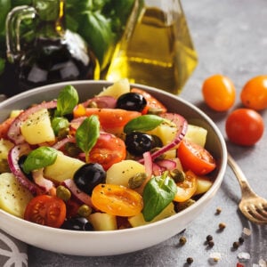 Potato salad with tomatoes, olives, capers, red onion, Italian style cuisine. Insalata Pantesca.